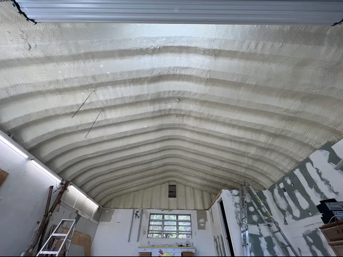 Spray polyurethane foam applied to the underside of a metal roof deck in Mitchellville