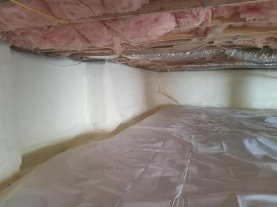Crawl space encapsulation with closed-cell spray foam for Commercial Roof Restoration in Mitchellville